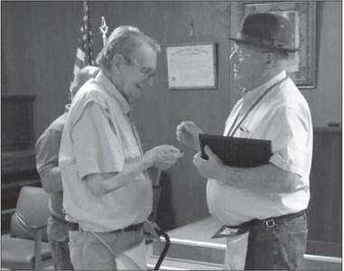 Past Grand Master Randy Gloves officiated the recent ceremony in which Bobby Papasan (pictured on left) was awarded a pin and certificate commemorating his 50-year tenure as a member of the Masonic lodge.