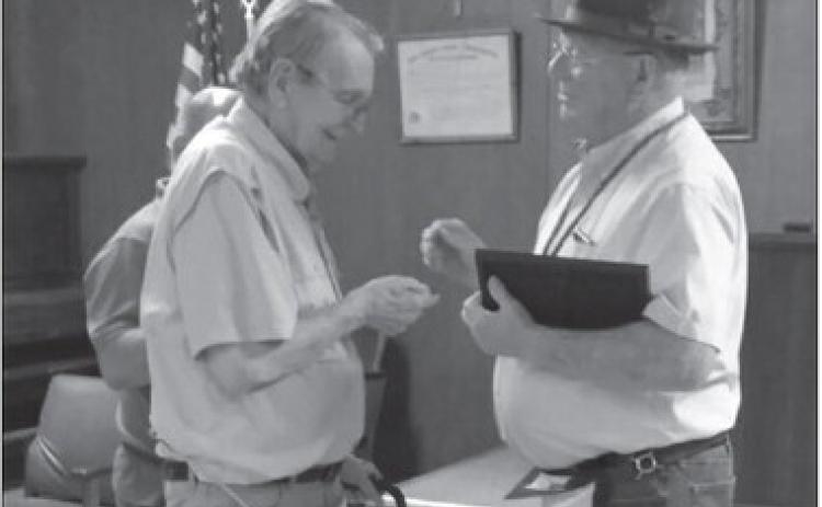 Past Grand Master Randy Gloves officiated the recent ceremony in which Bobby Papasan (pictured on left) was awarded a pin and certificate commemorating his 50-year tenure as a member of the Masonic lodge.